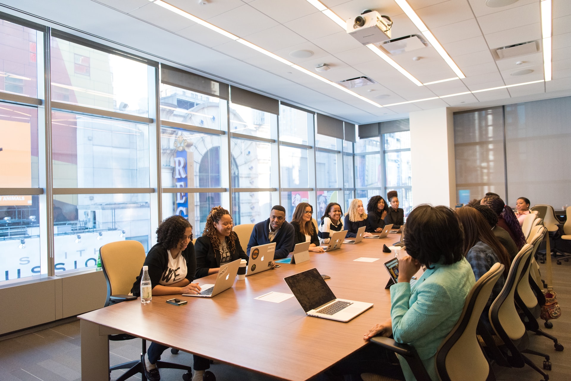 Business meeting with diverse team discussing contract disputes and business strategies.