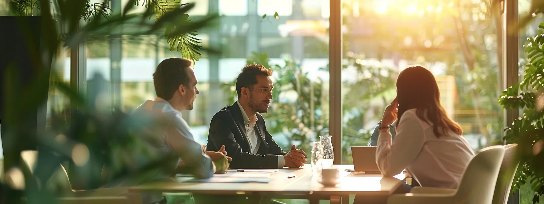 business professionals engaged in a serious discussion at a conference table.